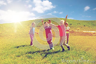 Group of happy kids running outdoors Stock Photo