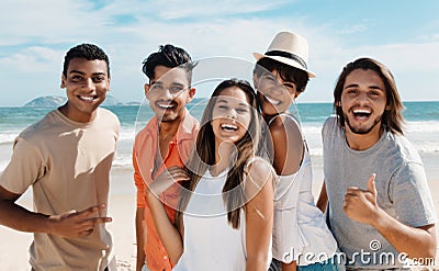 Group of happy latin caucasian and african american men and woman at beach Stock Photo