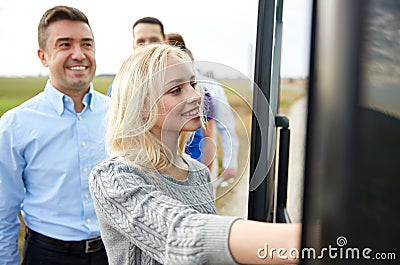 Group of happy passengers boarding travel bus Stock Photo