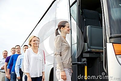 Group of happy passengers boarding travel bus Stock Photo