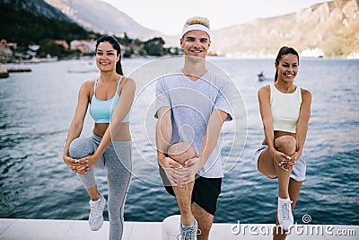 Group of happy people exercising outdoor. Sport, fitness, friendship and healthy lifestyle concept Stock Photo