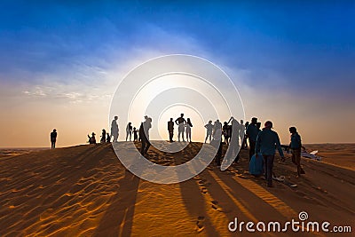 Group of happy people silhouettes in the desert Editorial Stock Photo