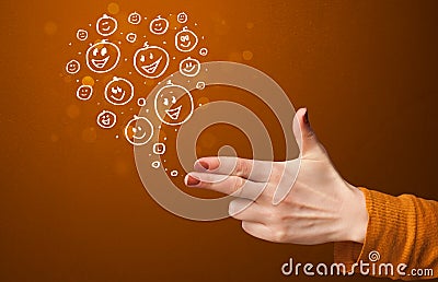 Group of happy smiley faces coming out of gun shaped hands Stock Photo