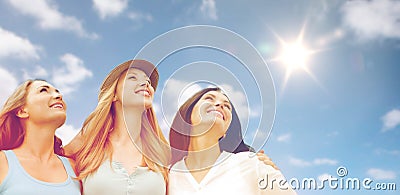 Group of happy smiling women or friends over sky Stock Photo