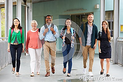 A group of happy teachers walking in a school corridor Stock Photo