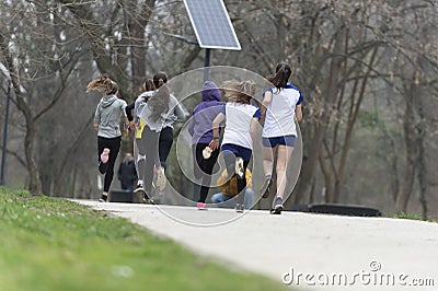 Group of happy teenage friends or sportsmen running marathon Editorial Stock Photo