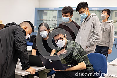 15 11 2021 group of happy young boys and girls with face mask work, discuss, study on assignment and teaching materials together Editorial Stock Photo