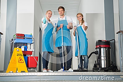 Group Of Happy Young Janitor Showing Thumbs Up Stock Photo