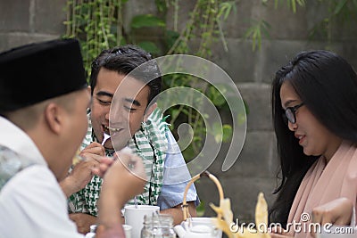 Group of happy young muslim having dinner outdoor during ramadan Stock Photo
