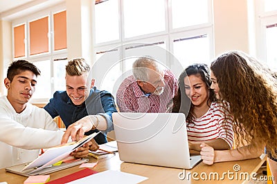 High school students and teacher with laptop. Stock Photo