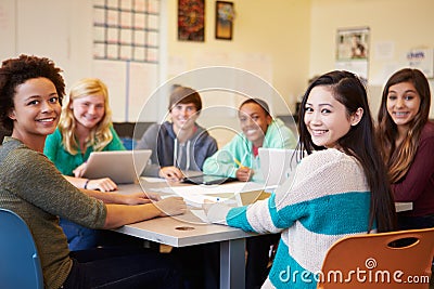 Group Of High School Students In Class Using Laptops Stock Photo