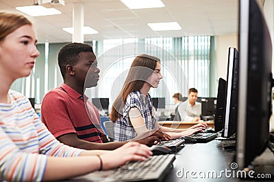 Group Of High School Students Working Together In Computer Class Stock Photo