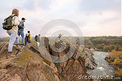 Group of hikers with backpacks at top of mountain Stock Photo