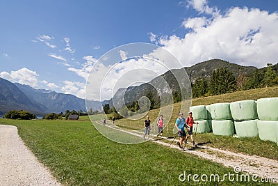 Group of hikers, slovenian alpinists, trekking in the Triglav Nationalpark, by Lake Bohinj, in Stara Fuzina, in the Julian alps Editorial Stock Photo