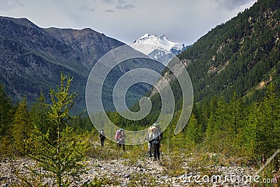 Group hiking, multi-day backpacking. Hiking in the Altai mountains, amazing landscape of the valley of the mountain range. Russia Editorial Stock Photo