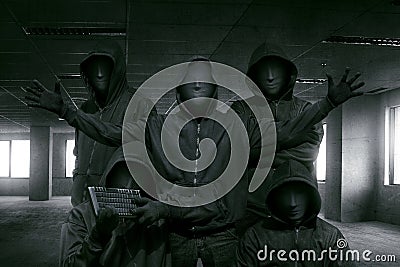 Group of hooded hacker with mask standing Stock Photo