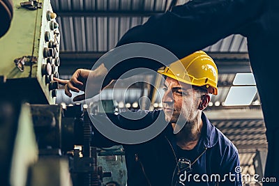 Group of Industrial factory maintenance engineers inspect relay protection system of machinery Stock Photo