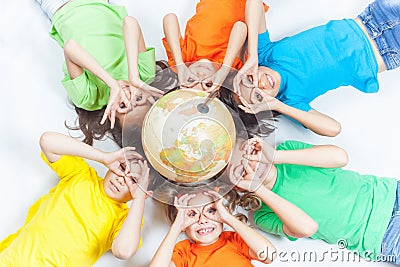 Group of international funny kids with globe earth Stock Photo