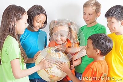 Group of international kids holding globe earth Stock Photo