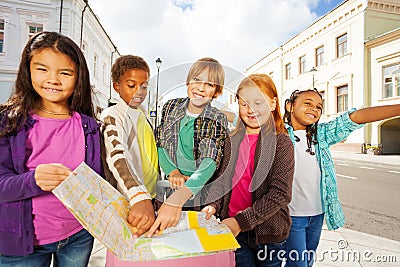 Group of international kids standing with luggage Stock Photo