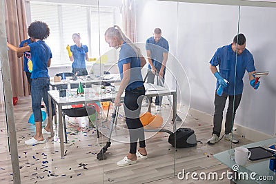 Group Of Janitors Cleaning Office Stock Photo