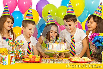 Group of joyful little kids with cake at birthday Stock Photo