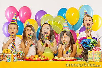 Group of joyful little kids having fun at birthday Stock Photo