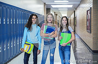 Group of Junior High school Students standing together in a school hallway Stock Photo