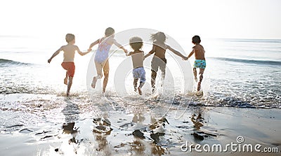 Group of kids enjoying their time at the beach Stock Photo