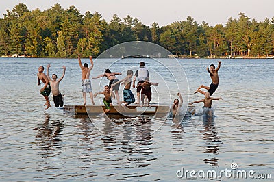 Group of kids jumping into Lake Stock Photo