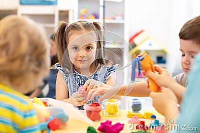 Group of kids play with modeling clay Stock Photo