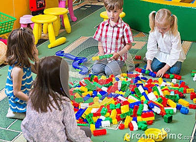 Group of kids playing with colorful constructor Stock Photo