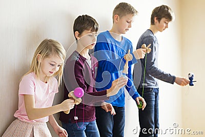 Group of kids playing kendama Stock Photo