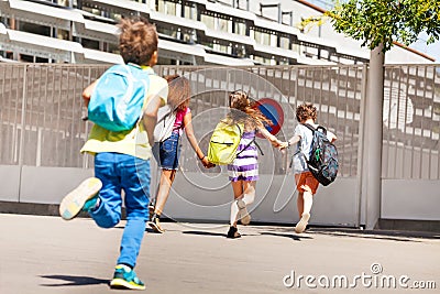 Group of kids run to school one after another Stock Photo