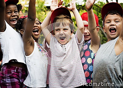 Group of kids school friends hand raised happiness smiling learn Stock Photo