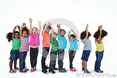 Group of kids standing in a line with raised arms Stock Photo