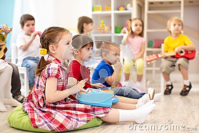 Group of kids 3-4 years old playing toy musical instruments. Early music education in kindergarten Stock Photo