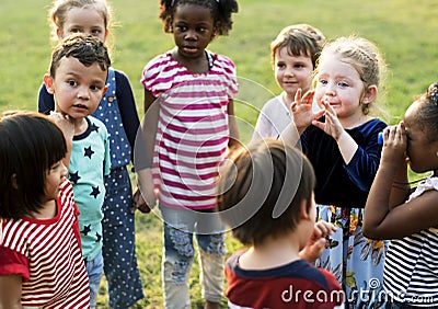 Group of kindergarten kids friends holding hands playing at park Stock Photo