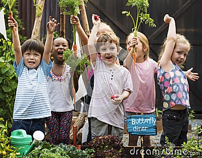 Group of kindergarten kids learning gardening outdoors Stock Photo