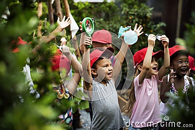 Group of kindergarten kids learning gardening outdoors Stock Photo