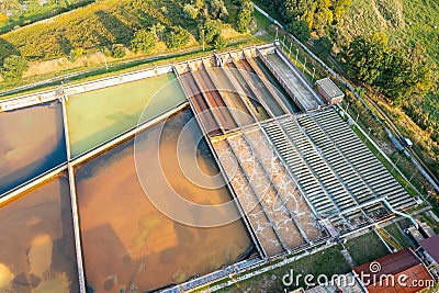 A group of large sedimentation tanks. Water settling, cleaning in a reservoir with biological organisms at a water station. Stock Photo