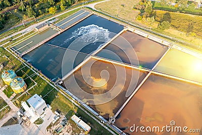 A group of large sedimentation tanks. Water settling, cleaning in a reservoir with biological organisms at a water station. Stock Photo