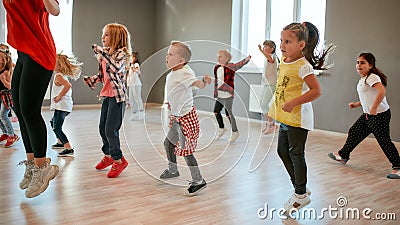 Full of energy. Group of little boys and girls dancing while having choreography class in the dance studio. Female dance Stock Photo