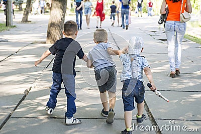 Group of little children running in park. Happy group of kids playing at the park. Editorial Stock Photo