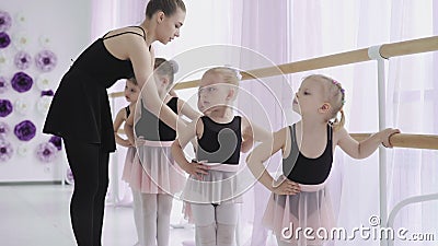 Group of little girls learning new dance moves during ballet lesson Stock Photo