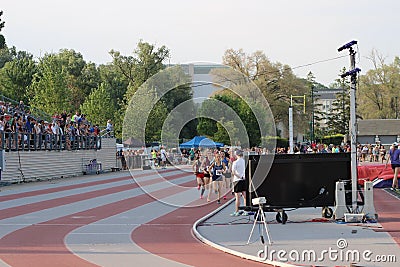 A group of runners on a track finishing a race Editorial Stock Photo