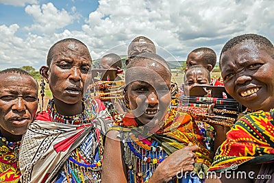 Group of Maasai people with traditional jewelry selling their ho Editorial Stock Photo