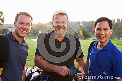 Group Of Male Golfers Marking Scorecard At End Of Round Stock Photo