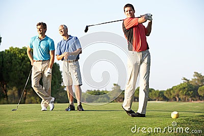 Group Of Male Golfers Teeing Off Stock Photo