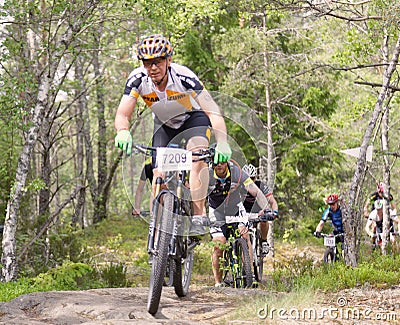 Group of male mountain bike cyclists in the forest Editorial Stock Photo